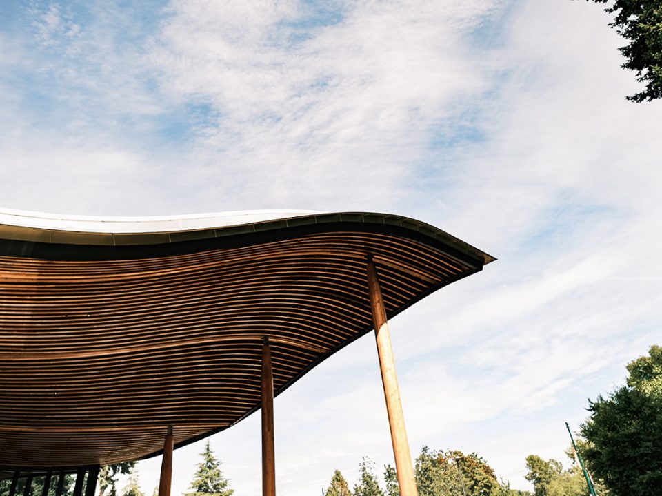 Vandusen building rooftop with clouded sky and trees
