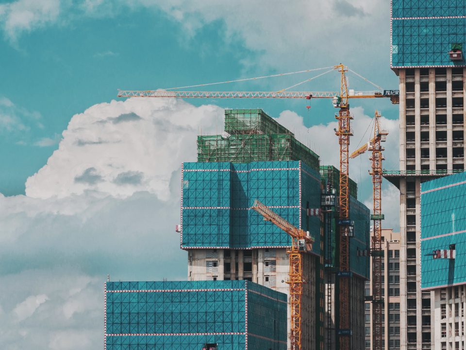 Blue themed skyscrapers being built with cranes